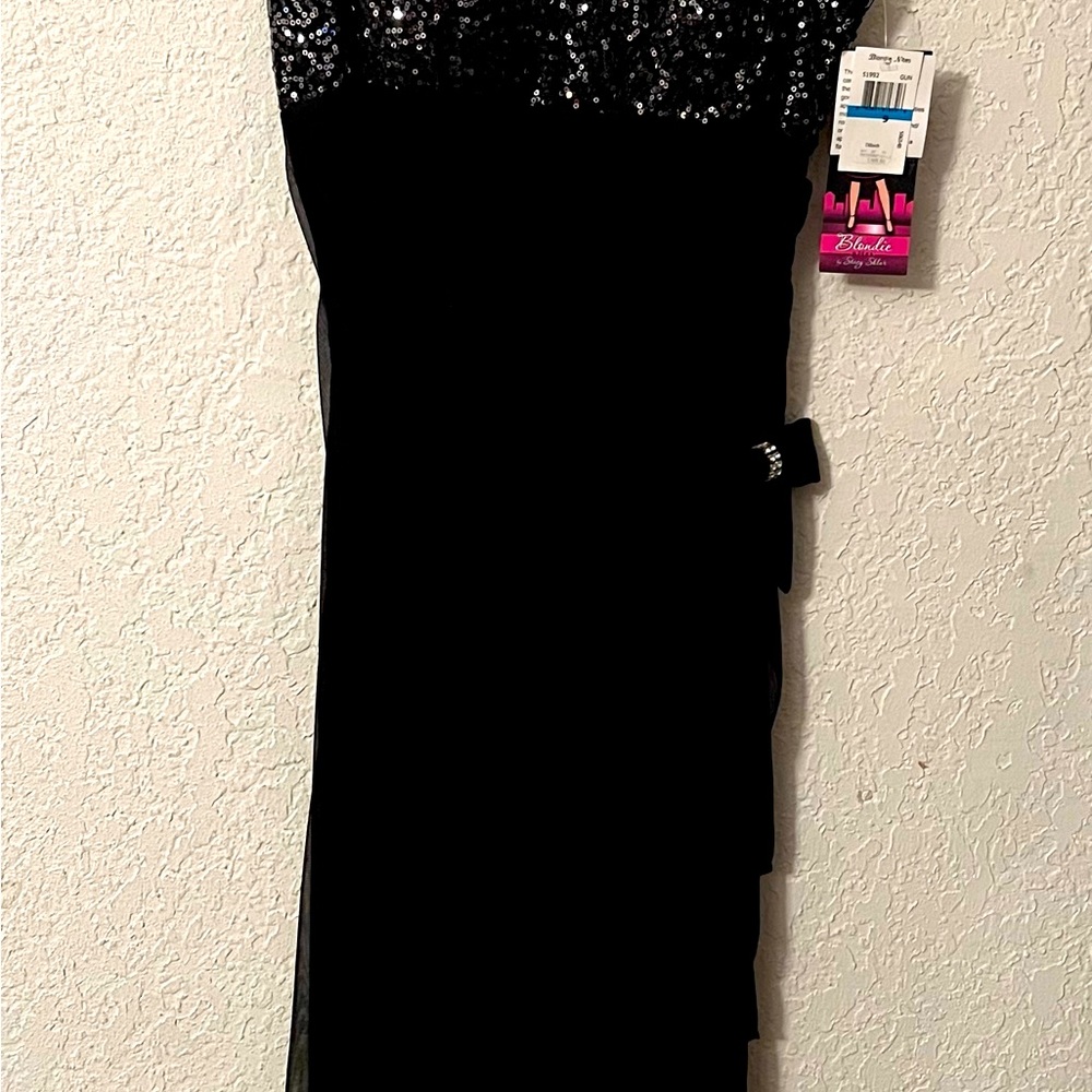 Long dress with sequin bodice and rhinestone details on straps and bow.